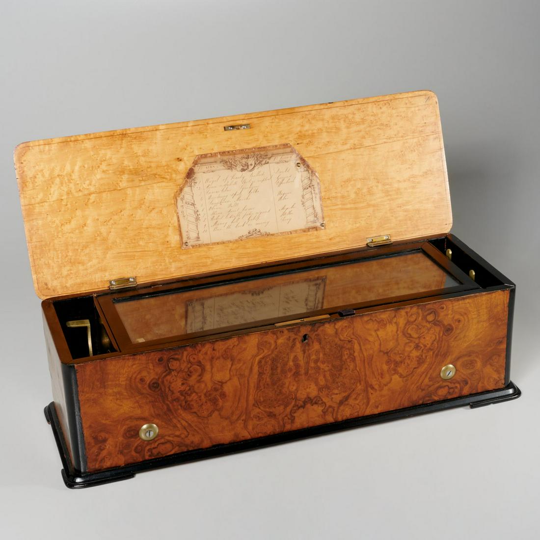 Large antique Swiss 10-air cylinder music box: Large antique Swiss 10-air cylinder music box, c. 1890, restored 1950s (according to note included), 75 note, horizontal brass cylinder, 10 songs listed, instructions on use included, 6.75"h x 22.25"l