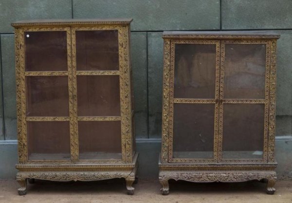 (2) similar antique Thai carved and giltwood manuscr: (2) similar antique Thai carved and giltwood manuscript cabinets, Bangkok Period, each tapering glazed panel case with read and green lacquered frame fitted with 2 doors on Naga feet, larger: 53"h x 3