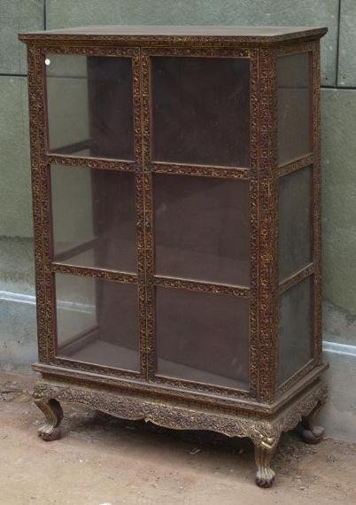 Antique Thai carved lacquered and giltwood manuscrip: Antique Thai carved lacquered and giltwood manuscript cabinet, Bangkok Period, the tapering glazed case with 2 doors on Naga feet, 56"h x 35"w x 18"d Provenance: Doris Duke's Southeast Asian Art Colle