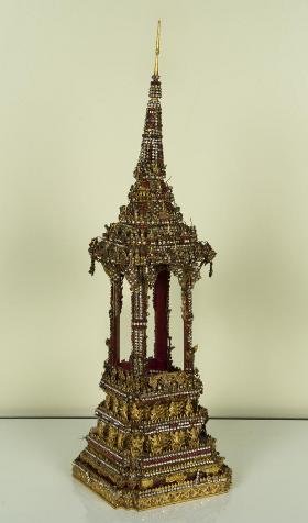 Antique Thai jeweled and gilt metal shrine: Antique Thai jeweled and gilt metal shrine, Probably Bangkok Period, of architectural form, encrusted with cut glass gems, 29"h x 8.5"squ. Provenance: Doris Duke's Southeast Asian Art Collection