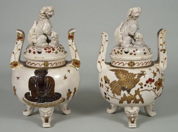 Pair large antique Japanese earthenware Koro and c: Pair large antique Japanese earthenware Koro and covers, Meiji Period, the pierced covers with Buddhist lion finials, each globular body with elongated handles on grotesque feet, the whole decorated i