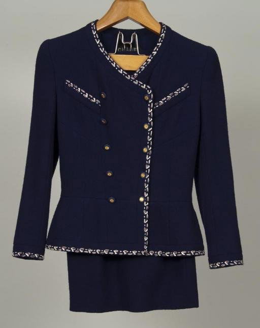 Chanel Couture skirt suit: Chanel Couture skirt suit, Circa 1980s, classically styled navy nubby wool with red and white trim, double "C" buttons, with matching skirt, 15"sh x 22.5"sl x 36"b x 22"l (jacket), 26"w x 24"l (skirt)