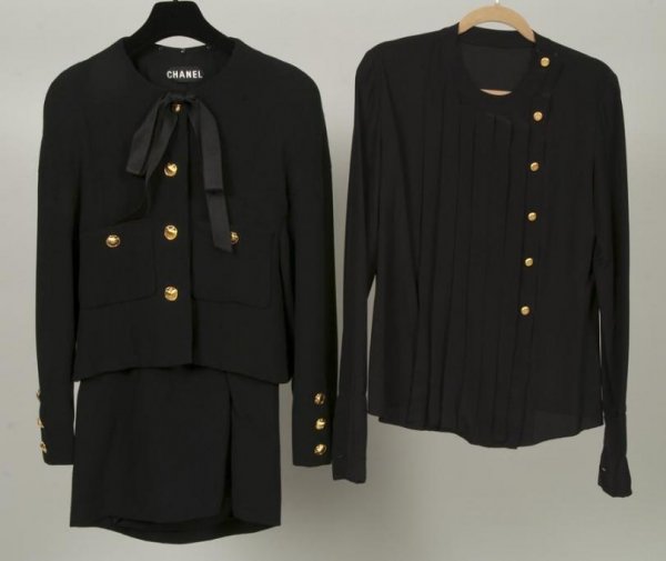Chanel Couture skirt suit and blouse: Chanel Couture skirt suit and blouse, Circa 1980s, black wool crepe jacket with satin bow and shell buttons, with black silk blouse and matching skirt, 16"sh x 26"sl x 36"b x 21.5"l (jacket), 16"sh x