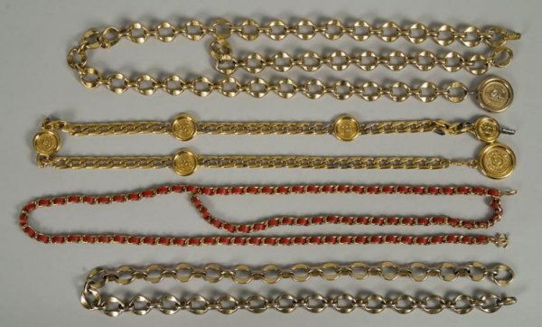 (4) Chanel gilt metal belts: (4) Chanel gilt metal belts, Circa 1970s - 1980s, including: (1) chainlink belt woven with coral leather and double "C" charm, 36"l; (1) gilt metal chainlink belt, 31"l; (1) gilt metal link belt with