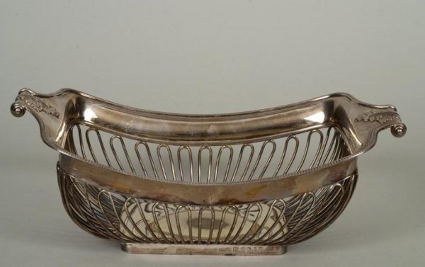 George III sterling silver cake basket: George III sterling silver cake basket, Sheffield, circa 1809, maker's marks those of Thomas Watson & Co., rectangular in shape with leafy scroll handles and looped wire body, 4.25"h x 12"l x 6.75"d, 