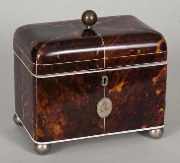 Late Regency ivory and silver mounted tortoiseshel: Late Regency ivory and silver mounted tortoiseshell tea caddy, 19th century, the domed top with ball finial opening to a zinc lined interior on silver plated ball feet, 7.5"h x 8"l x 5.25"d