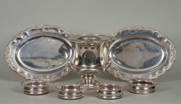 Sheffield-plated hollowware by Matthew Boulton and: Sheffield-plated hollowware by Matthew Boulton and others, 19th century, including: (1) bottle cooler by the Matthew Boulton Plate Co., Birmingham; (1) pair meat platters; and (2) pairs bottle coaster