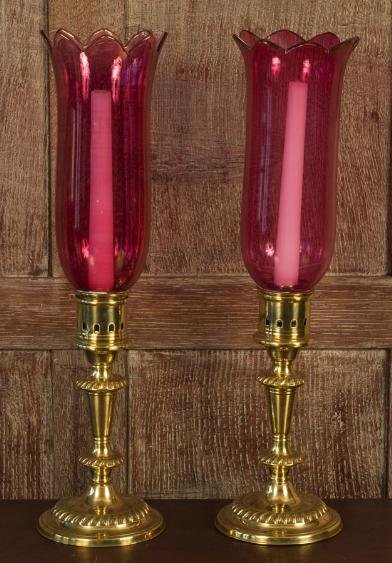 Pair English brass candlesticks with cranberry sha