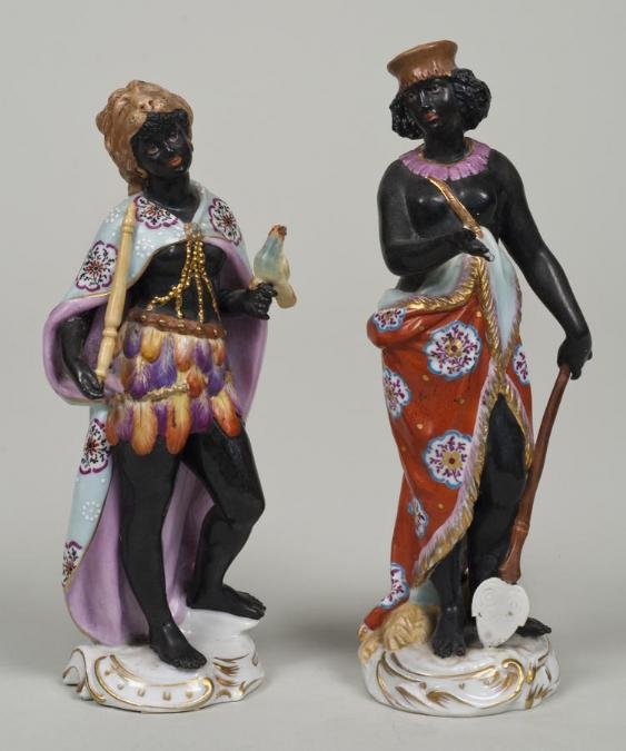 Pair antique Frankenthal porcelain blackamoor figu: Pair antique Frankenthal porcelain blackamoor figures, 19th Century, each modeled as a standing female figure in stereotypical tribal garb, underglaze blue factory marks on underside of base, 6.25"h x