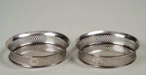 Pair Italian Neo-classical silver bottle coasters: Pair Italian Neo-classical silver bottle coasters, Early 19th Century, Venice, each reticulated gallery with everted rim, hallmarked, 1.25"h x 5.5"dia., approx. 8.9 ozt. Provenance: Frank S. Schwarz &