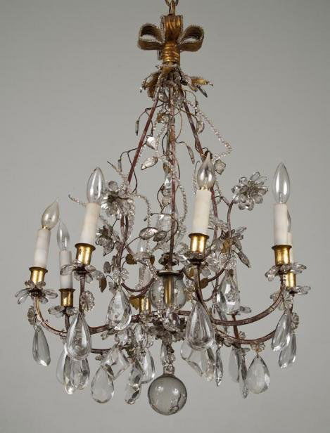 Documented French chandelier by Maison Bagues: Documented French chandelier by Maison Bagues, Mid 20th century, the gilt and silvered 8-arm frame hung with crystal drops, beaded tendrils and flower heads gathered to a bow-knotted top, 34"h x 21"di