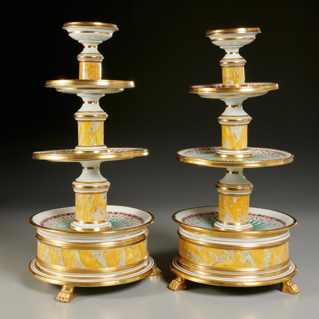 Pair Palais Royal, Paris tiered dessert stands: Pair Palais Royal, Paris tiered dessert stands, 19th/20th c., gilt and polychrome painted porcelain, each tier decorated with radiating flowers, on faux marble decorated columns supports, red stamp ma