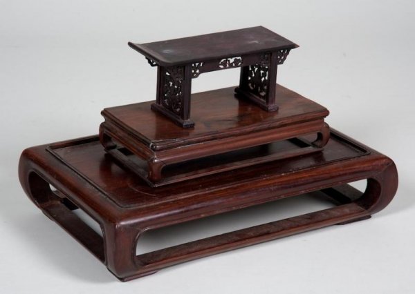(3) antique Chinese carved hardwood table stands: (3) antique Chinese carved hardwood table stands, Qing Dynasty, largest: 4"h x 18"l x 11.5"d, smallest: 4"h x 8.75"l x 3"d Provenance: The Estate of Sir Edwin Manton, NY
