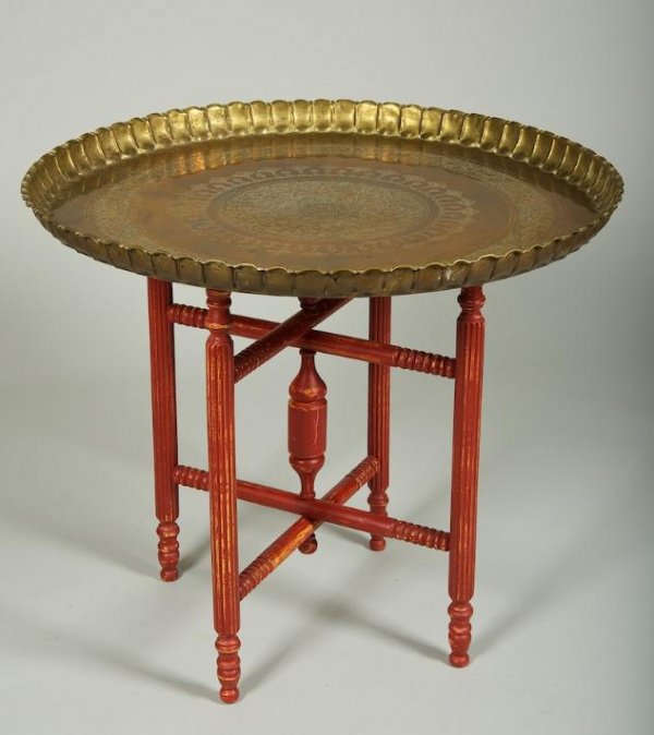 Islamic engraved brass tray on red painted table s: Islamic engraved brass tray on red painted table stand, Early 20th century, 28"h x 32.5"dia.