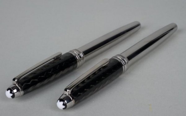 (2) Montblanc Meisterstuck Solitaire pens: (2) Montblanc Meisterstuck Solitaire pens, 20th century, carbon fiber and steel, fountain and rollerball