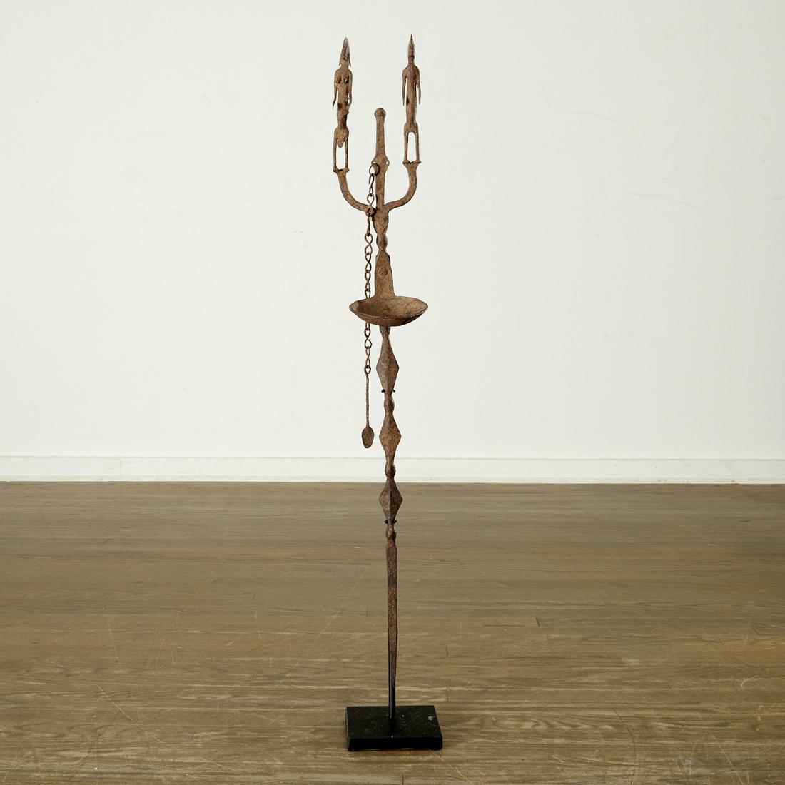 Bamana Peoples, iron ceremonial oil lamp: Bamana Peoples, iron ceremonial oil lamp, Mali, with double figural top, 34.5"h x 4.5"w x 4.25"d Provenance: Estate of Distinguished Professor Philip Gould, NYC Notes/Literature: Professor of Chinese 