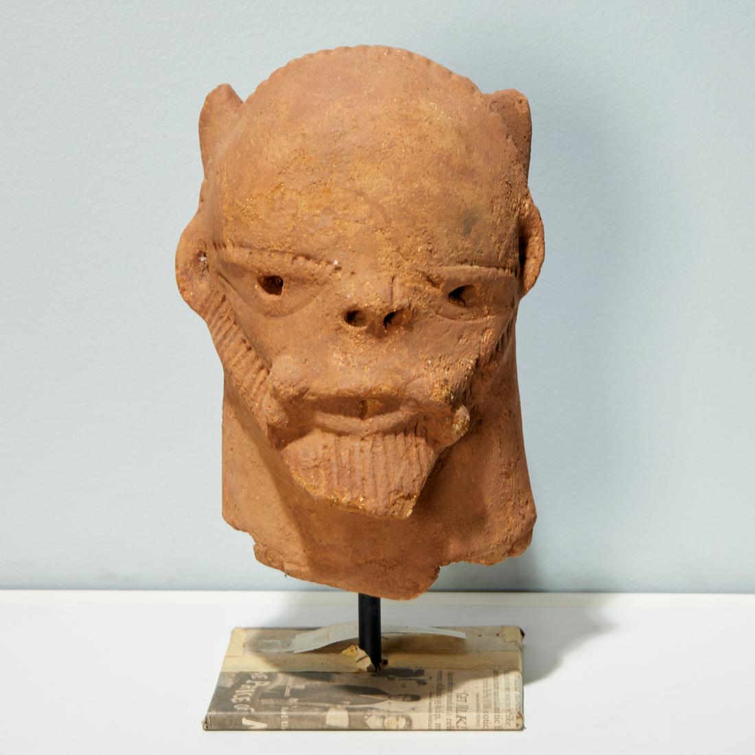 Katsina Culture, terracotta head: Katsina Culture, terracotta head, Possibly 200 BCE-100CE, Nigeria, hand-moulded with incised features and coiffure and beard, on custom metal stand, 9"h x 6"w x 5"d (head) Provenance: Estate of Distin