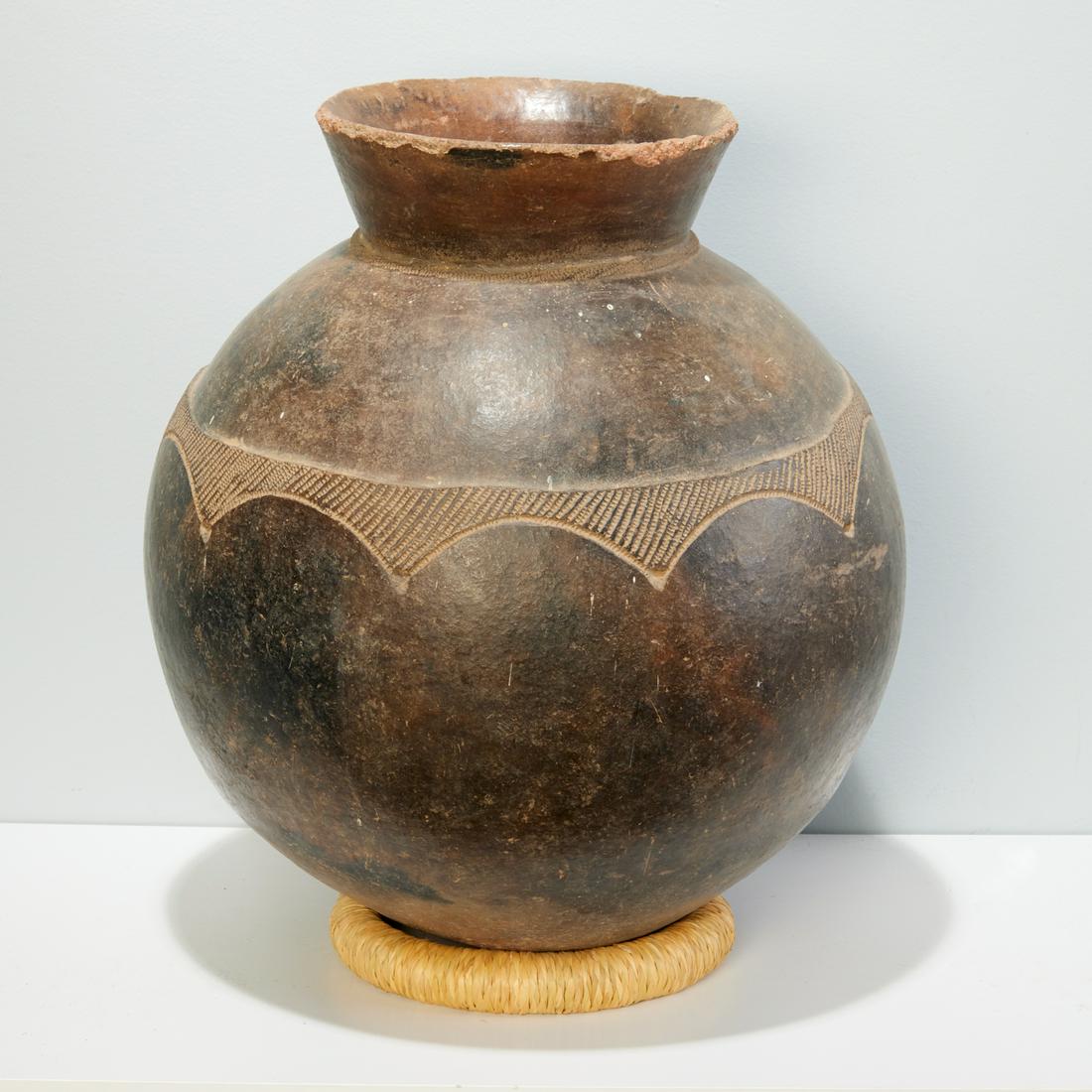 Large Lobi pot: Large Lobi pot, Burkina Faso, glazed earthenware, rounded bottom, incised decorated bands, approx. 16"h x 14"dia Provenance: Estate of Distinguished Professor Philip Gould, NYC Notes/Literature: Profe