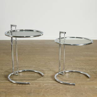 Eileen Gray, pair chrome E1027 side tables: Eileen Gray, pair chrome E1027 side tables, Designed 1926, France, chromed tube metal, glass, with adjustable height table top, 25"h x 20"dia