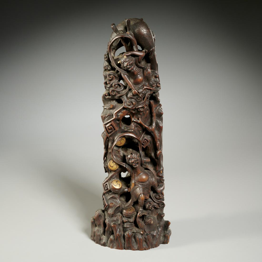 Finely carved, inlaid Meiji Okimono totem: Finely carved, inlaid Meiji Okimono totem, Late 19th c., Japan, elaborate carving depicting Fujin, god of wind, standing below his bag of wind, together with Raijin, god of thunder, framed by four gil