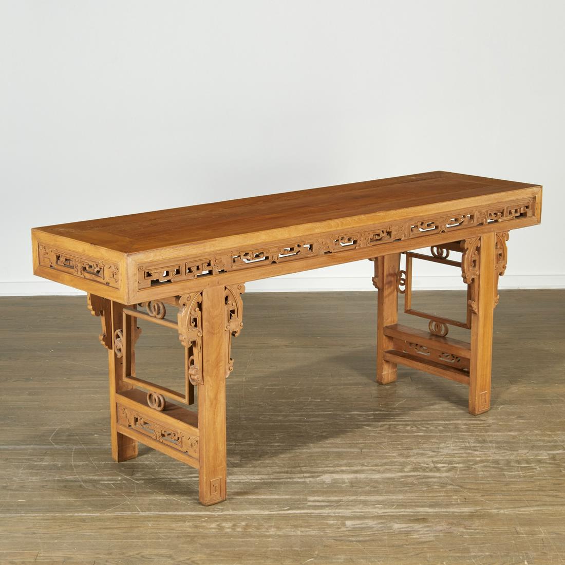 Chinese archaistic carved altar table: Chinese archaistic carved altar table, 20th c., the rectangular top over pierce carved frieze, raised on carved trestle supports set with openwork flanges, 31"h x 70"l x 19.5"w
