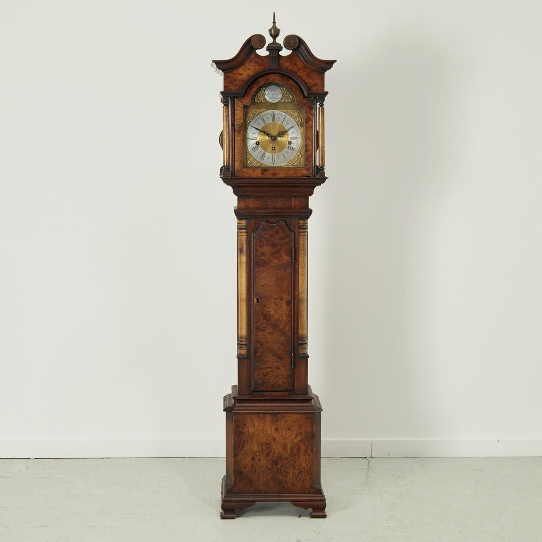 John Thompson, grandmother clock: John Thompson, grandmother clock, 20th c., London, walnut and mahogany case, with scrolled open pediment top, hinged door opens to Roman numeral dial, flanked by columnar supports, on bracket feet, ma