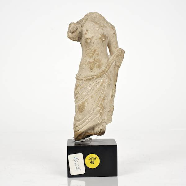 Syrian or Egyptian carved limestone torso of a wom: Syrian or Egyptian carved limestone torso of a woman, On lacquered wood stand, 8.25"h x 3.75"dia. (excl. stand) Provenance: From an important and internationally renowned single owner collection sol