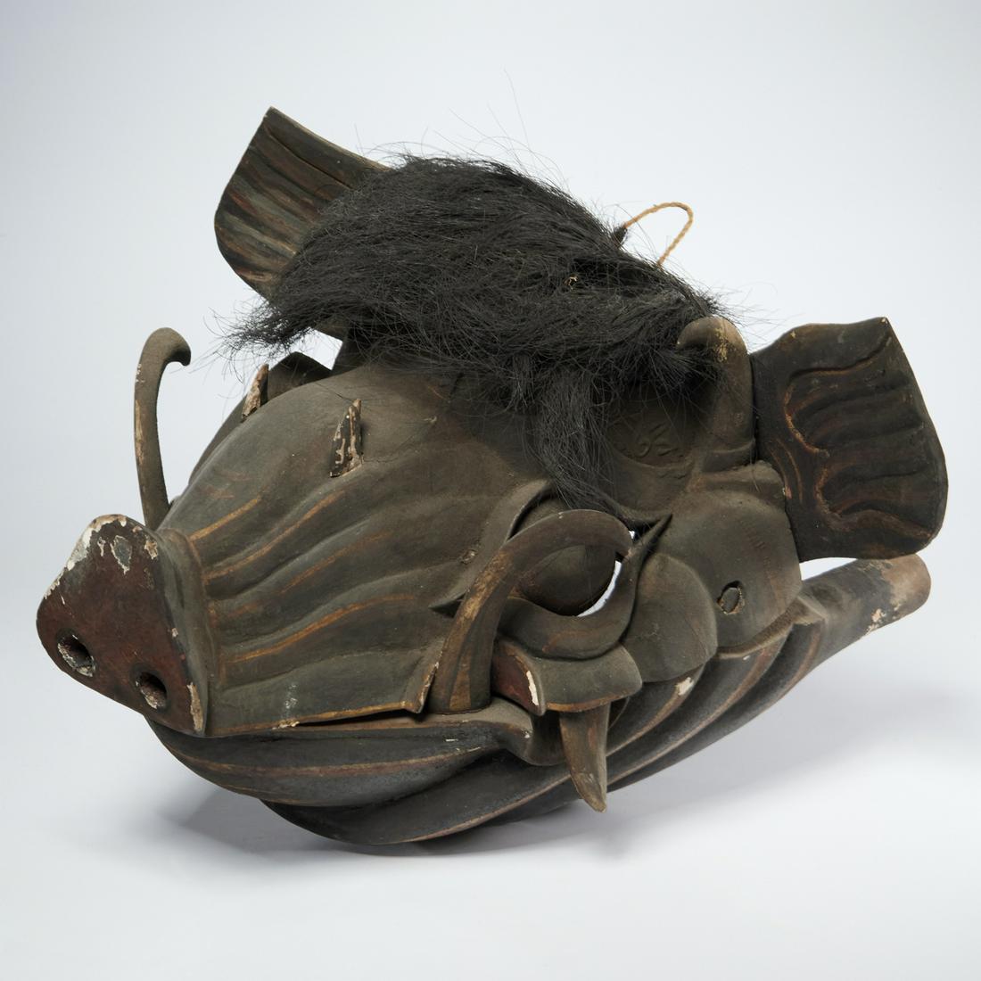 Balinese carved and painted boar mask: Balinese carved and painted boar mask, 20th c., wood, pigment and horsehair, with moveable jaw on dowel hinge, carved handles extend to the rear, approx. 12"h x 18"l x 16"w Provenance: The Collection 