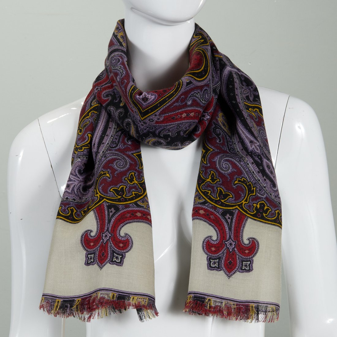 Etro Milano silk & wool scarf: Etro Milano silk & wool scarf, 21st c., with center paisley print in purple and burgundy, fringed edges, approx. 58"l x 26"w Provenance: From an Upper East Side Collection