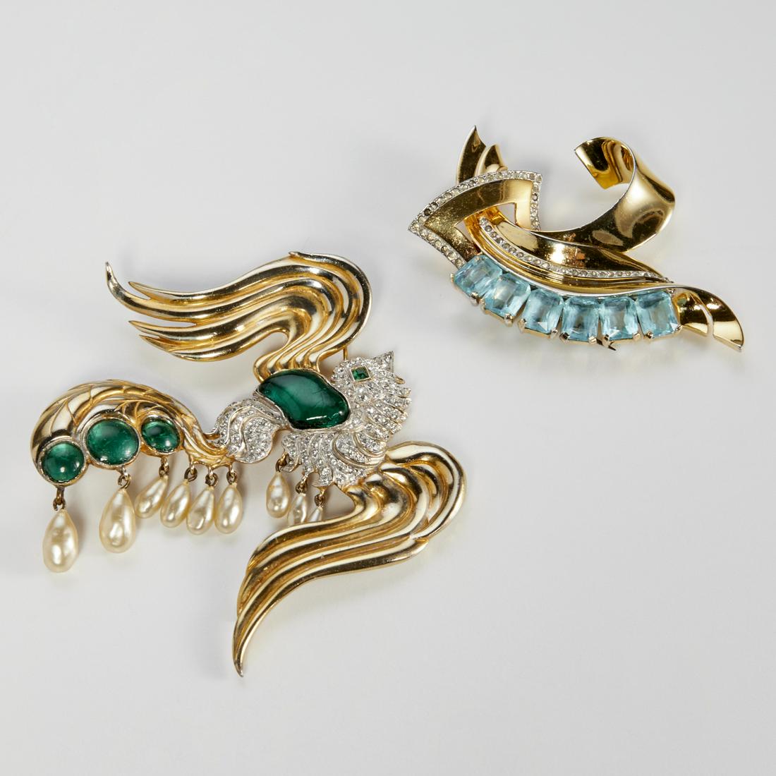 (2) Vintage fur clips, incl. Mazer: (2) Vintage fur clips, incl. Mazer, 20th c., both in gold metal, (1) with pave set rhinestones and aquamarine colored stones in scrolled ribbon form, marked Mazer, approx. 3"h x 2"w, (1) Eisenberg sty