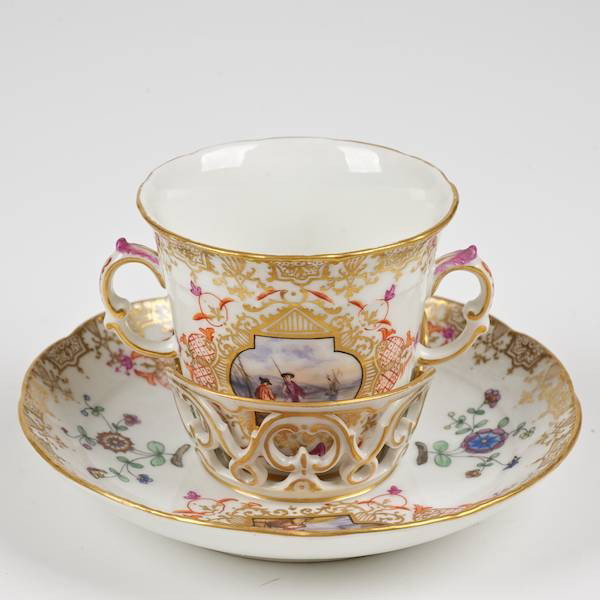 KPM Horoldt style decorated trembleuse cup and sa: KPM Horoldt style decorated trembleuse cup and saucer, 19th c., underglaze blue factory mark, 3.5"h x 5.5"dia.