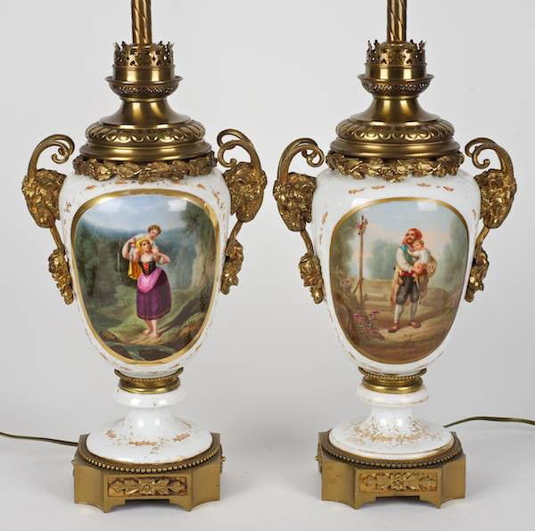 Pair bronze mounted Paris porcelain urn lamps: Pair bronze mounted Paris porcelain urn lamps, 19th c., ram's head terminals, 14"h x 9.75"w (excl. fittings), 24"h (total without harps)