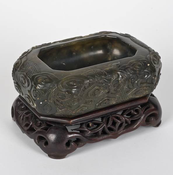 Antique Chinese green soapstone dragon bowl: Antique Chinese green soapstone dragon bowl, 19th/20th c., on hardwood stand, 2"h x 6.5"l x 4.5"w (excl. stand)