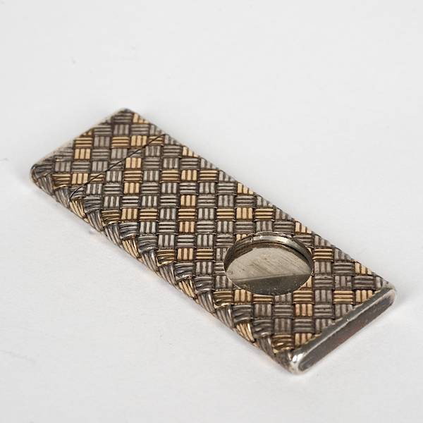 Tiffany & Co. sterling and 14K gold cigar cutter: Tiffany & Co. sterling and 14K gold cigar cutter, 20th c., basketweave design, 2"l, approx. 0.86 ozt. (total)
