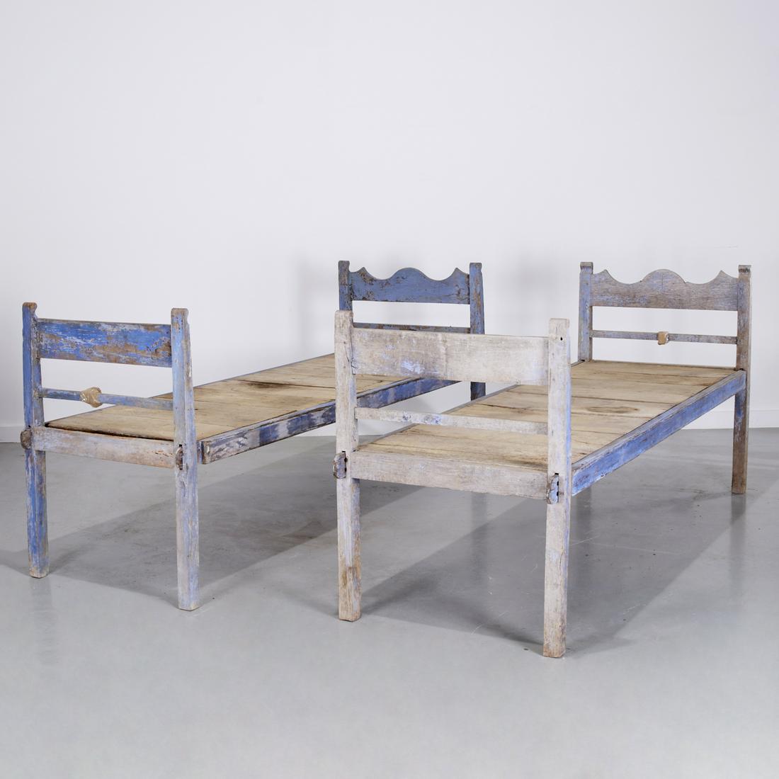 Pair antique Provincial blue painted daybeds: Pair antique Provincial blue painted daybeds, 19th c., possibly American, the head and footboards slotted to hold platform, 21.5"h (to top of platform), 38.5"h (to top of head and footboards), 79.5"l