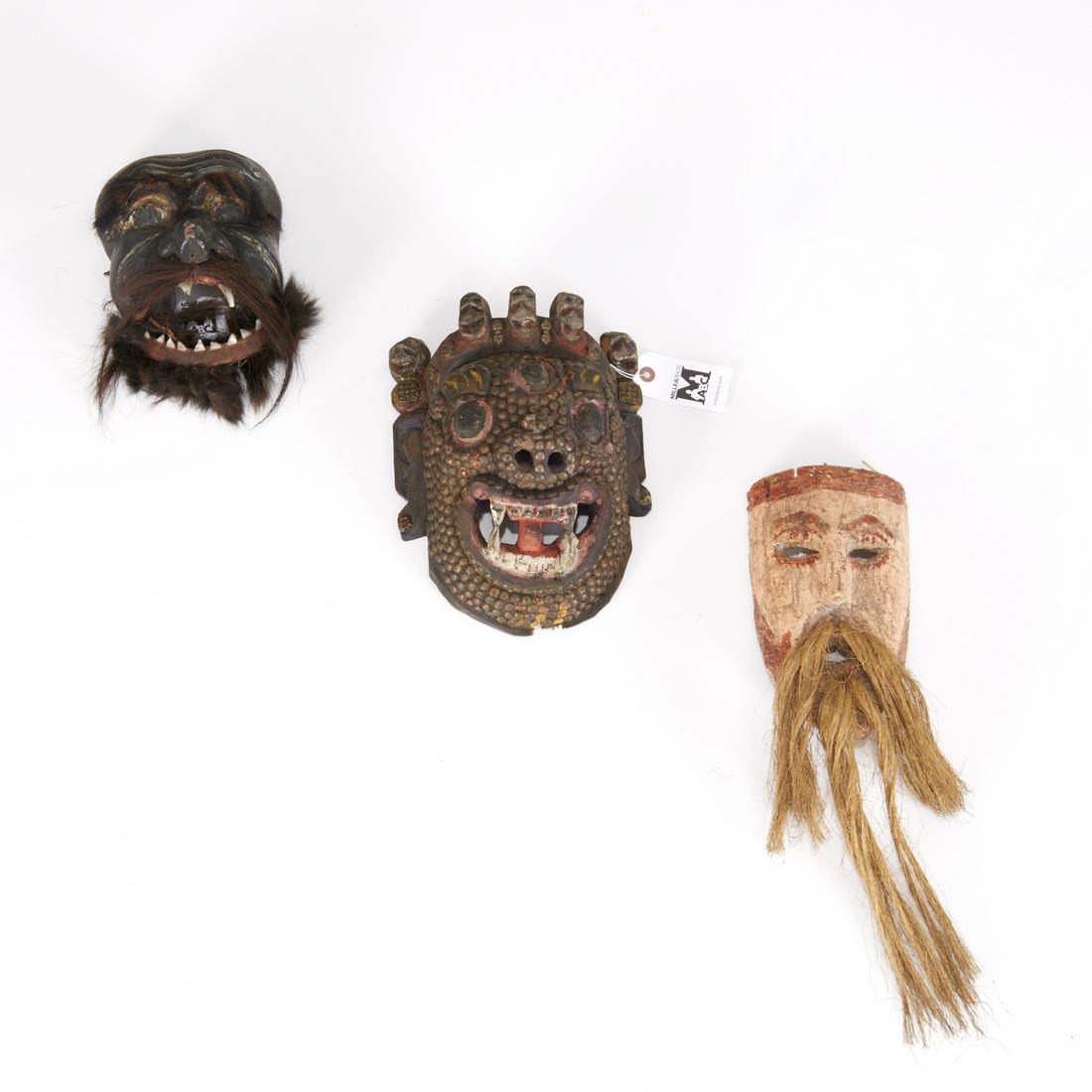Group (3) Indonesian masks: Group (3) Indonesian masks, 20th c., carved and painted wood, one with plant fiber beard and mustache, one with protruding teeth, moveable lower jaw and animal hair eyebrows, beard and mustache, the t
