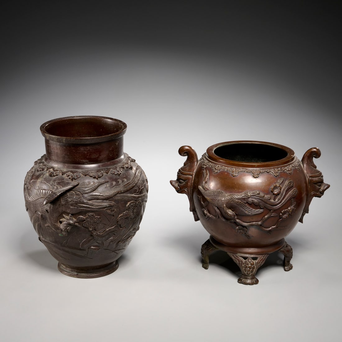 (2) Japanese patinated bronze vessels: (2) Japanese patinated bronze vessels, Meiji Period (late 19th c.), including a light brown orb-form censer, decorated in high relief with birds and Prunus branches, grotesque mask handles, the interi