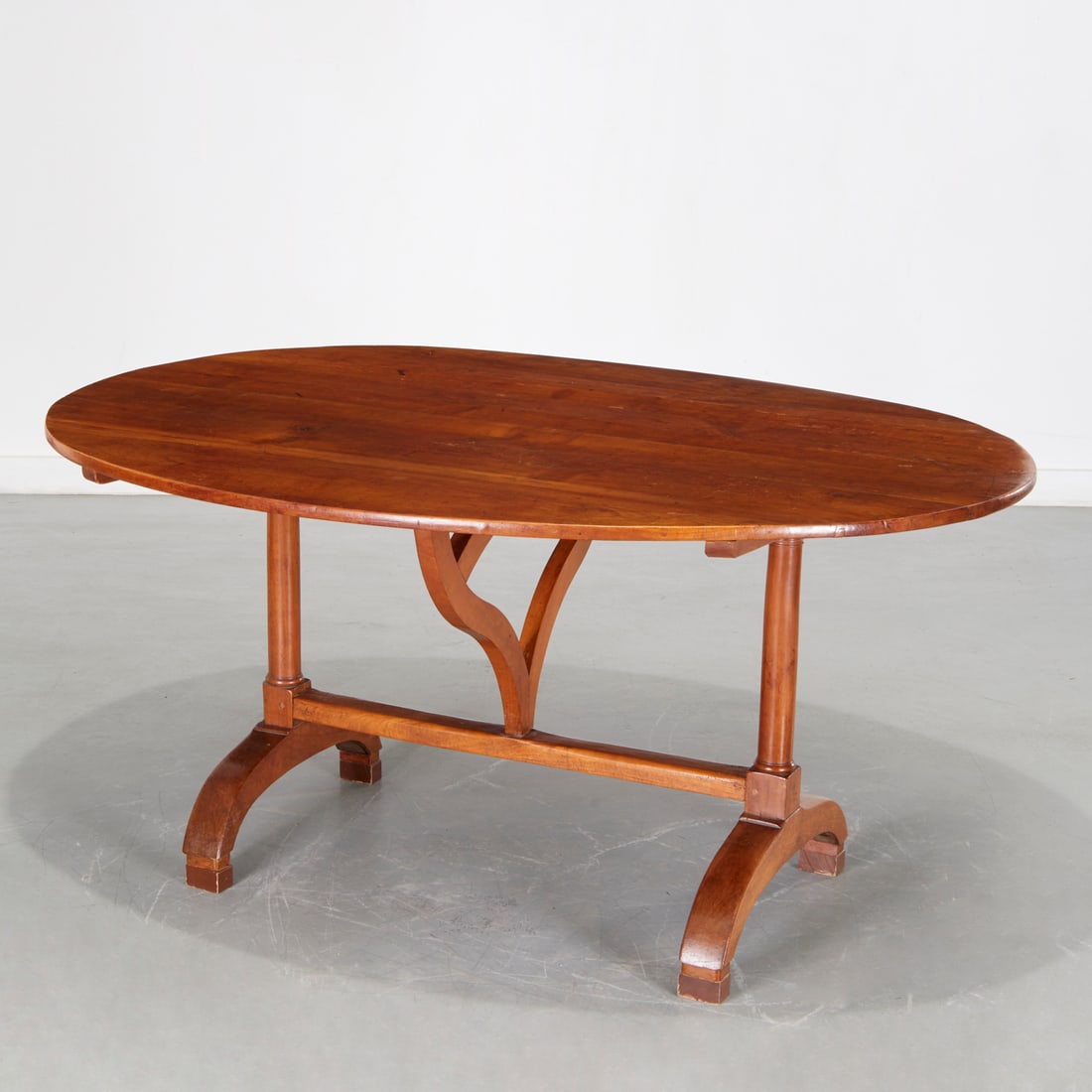 Antique Provincial French wine tasting table: Antique Provincial French wine tasting table, 19th c., oval walnut top on trestle base with unusual pivoting butterfly support, 29"h x 60.5"l x 46"w (open), 52"h (closed)