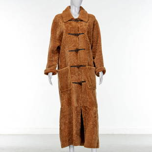 Lucca Bianco Italy shearling coat: Lucca Bianco Italy shearling coat, 21st c., Made in Argentina, camel with sheared exterior, toggle closure, (2) patch pockets, size M, approx. 40"b, 53"l, 25"sl