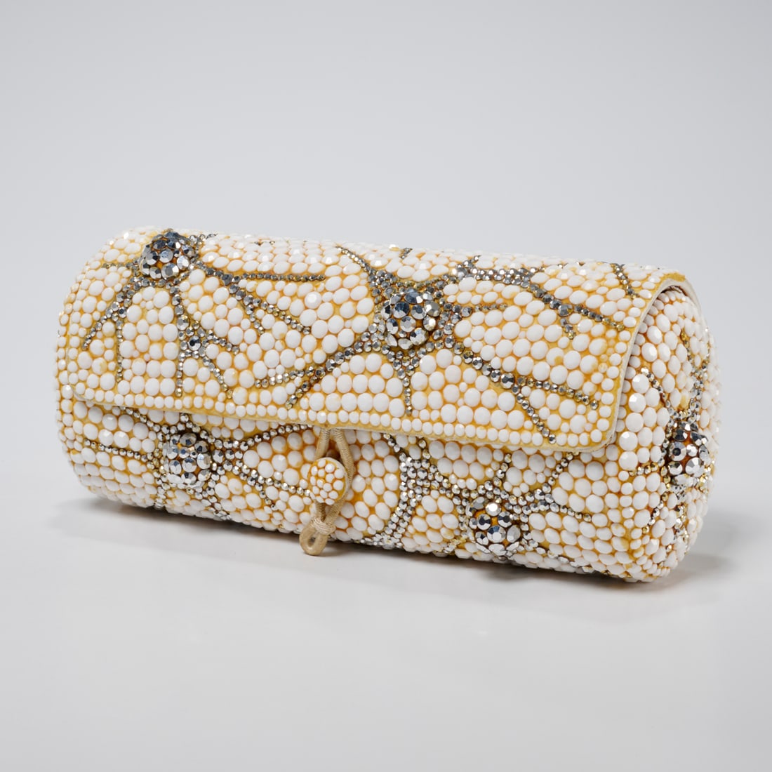 Vintage Koret white & silver bead evening clutch: Vintage Koret white & silver bead evening clutch, 1950s, barrel style, metallic beads, silver foiled leather interior with Koret stamp, approx. 3"h, 7"w Provenance: A Private Collection: 200 West 86th