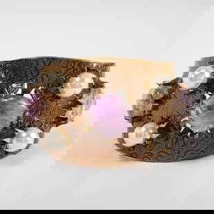 Chanel cuff bracelet with faux pearls: Chanel cuff bracelet with faux pearls, 1997, Made in France, metal with swirl design, with center mounted amethyst surrounded by (2) amethyst stones & (6) faux pearls, CC mark within design, stamped o