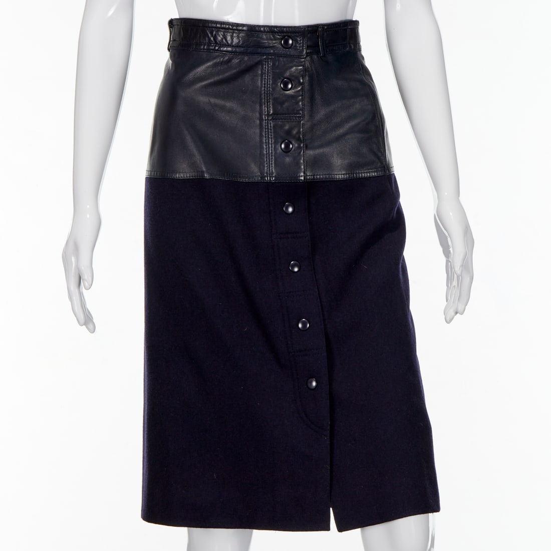 Escada navy leather & wool skirt: Escada navy leather & wool skirt, c. 1980s, Made in W. Germany, with upper section in leather, off center snap buttons, 1.5" belt loop, fully lined in Escada logo print, size 34, approx. 27"w, 25"l Pr