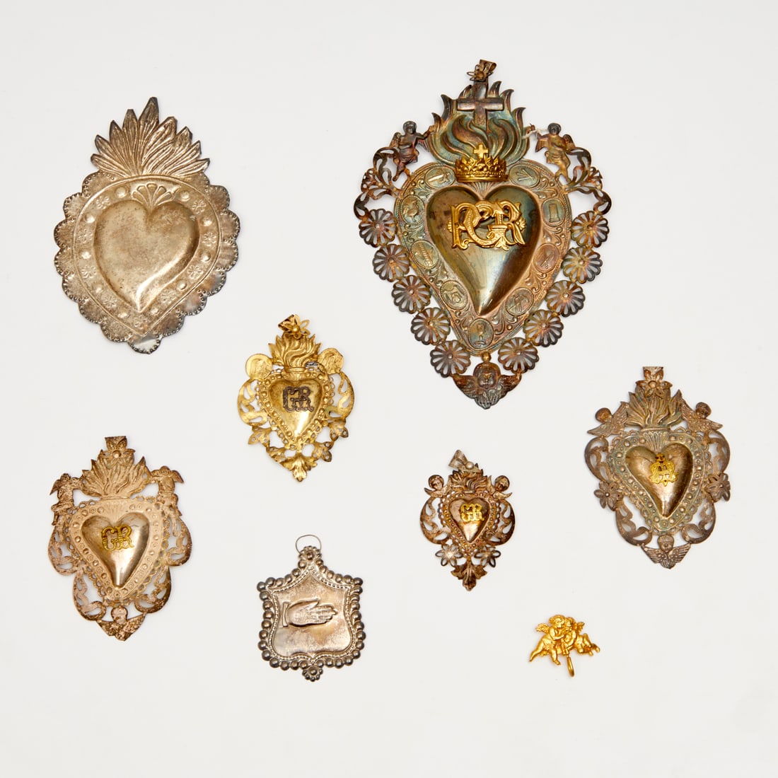 Collection antique 'Sacred Heart' Ex Votos: Collection antique 'Sacred Heart' Ex Votos, 19th/20th c., likely Italy and Mexico, (8) pieces, one stamped "925", 9.5"h x 6.5"w (largest), 1.5"h x 1.75"w (smallest) Provenance: The Collection of Linn 