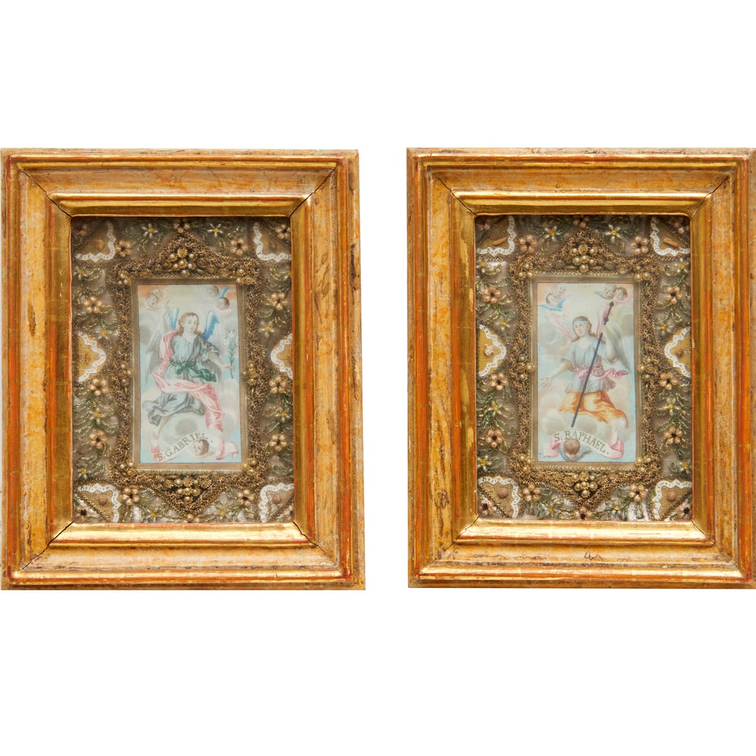 Pair Continental framed reliquaries: Pair Continental framed reliquaries, 19th c., likely Germany, watercolor paintings of St. Raphael and St. Gabriel, surrounded by tinsel, beads and textiles, each containing six labeled relics, framed