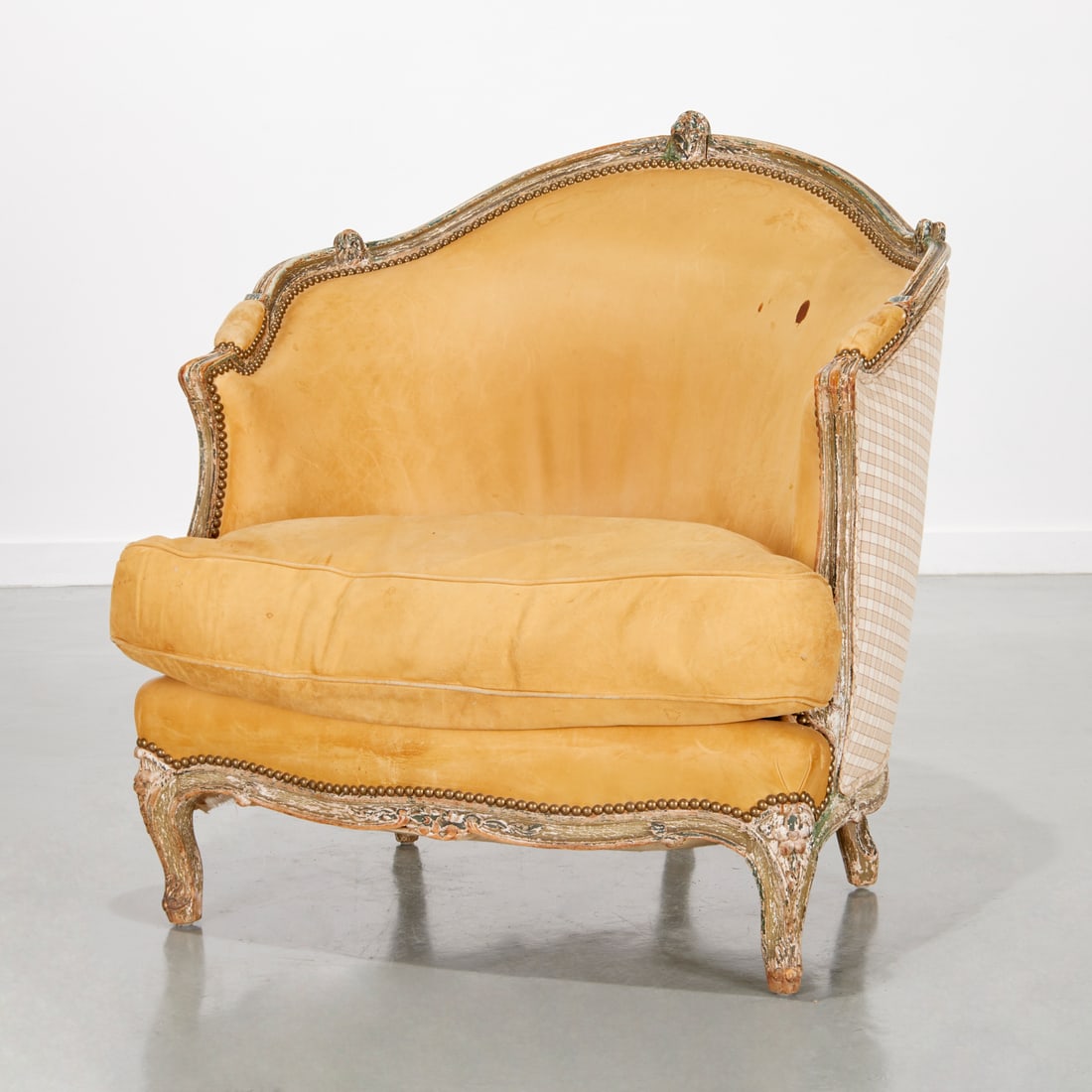 Nice Louis XVI style leather upholstered marquise: Nice Louis XVI style leather upholstered marquise, 19th c., France, green painted channel-carved frame, the curved back and padded seat upholstered in a tan leather, the chair exterior upholstered in 