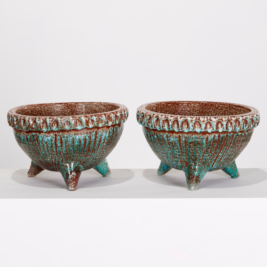 Pair Accolay Mid-Century ceramic jardinieres: Pair Accolay Mid-Century ceramic jardinieres, Mid-20th c., France, blue and brown glazed pottery, the ribbed bowl on tripod legs, faintly signed to underside, 9"h x13"dia Provenance: Property from a L