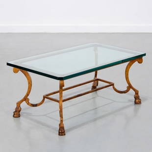 Maison Ramsay style coffee table: Maison Ramsay style coffee table, 20th c., half-inch glass tabletop, gilt metal base with paw feet, unsigned, 15"h x 34"l x 20"w Provenance: A Private Collection: 502 Park Avenue, NYC