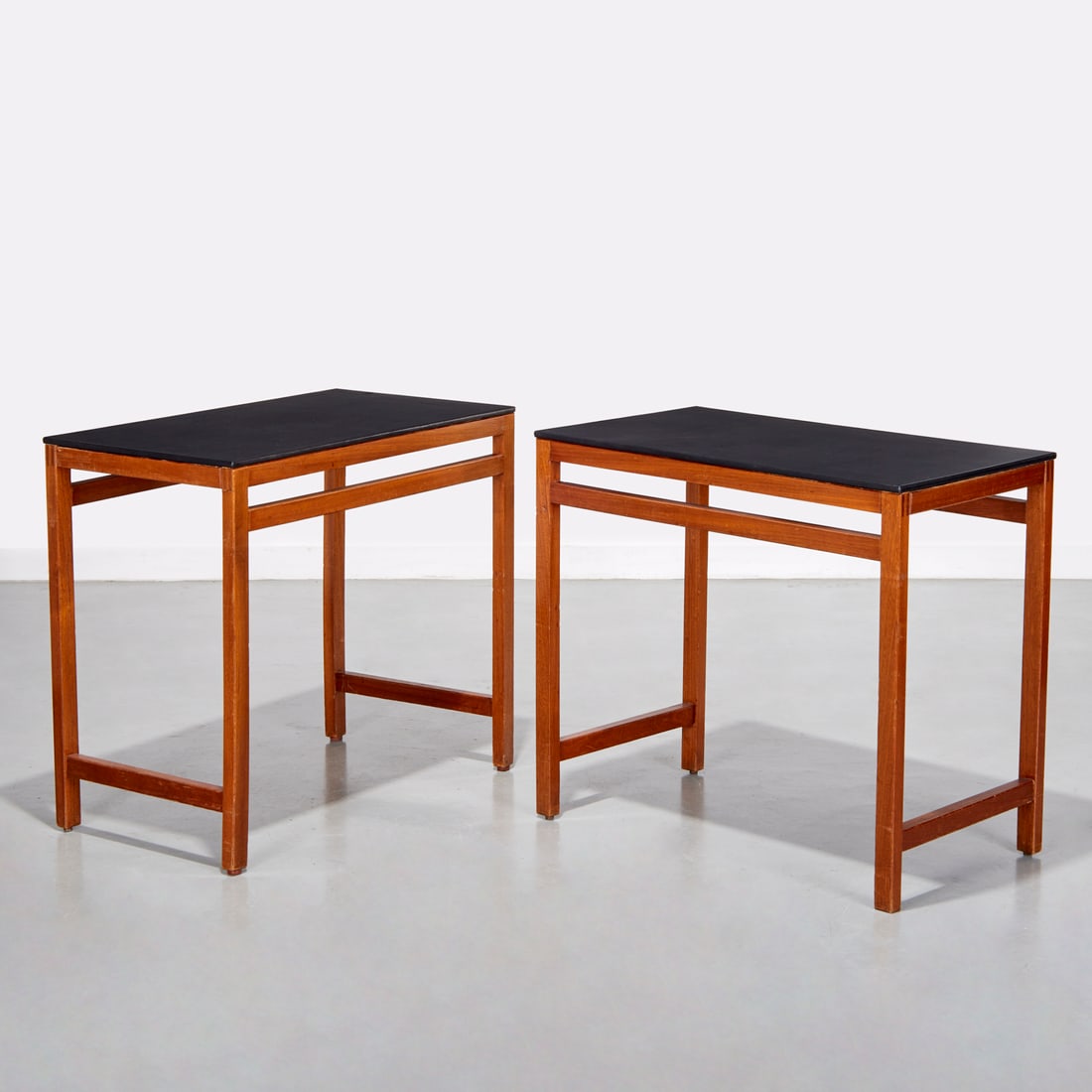 Andre Sornay, pair leather top consoles, signed: Andre Sornay, pair leather top consoles, signed, c. 1950s, France, mahogany frame, leather wrapped melamine top, maker's decal label to underside, 29"h x 33"w x 18"d Provenance: A Gentleman's Collecti