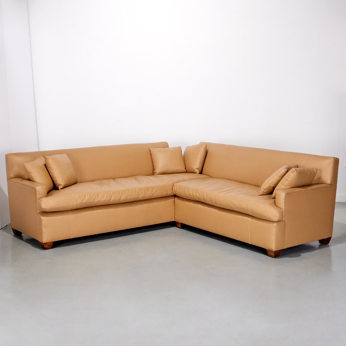 Custom JMF style leather sectional: Custom JMF style leather sectional, 21st c., USA, tan leather on wood block feet, with tight back and single seat cushions, center cutout to accommodate pedestal (included), designed or sourced by Sel