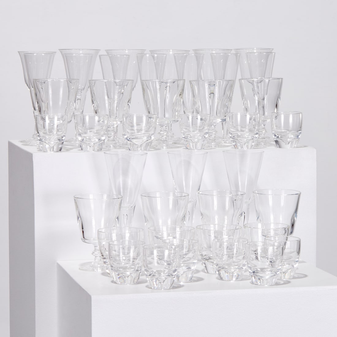 Steuben, large assembled stemware set: Steuben, large assembled stemware set, 20th c., USA, colorless glass, (41) pieces, including (3) tall cocktail flutes, 9"h, (7) champagne flutes, 8"h, (6) wine glasses, 8"h, (9) water goblets, 6"h, (4